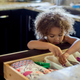 Child rummaging through kitchen drawer